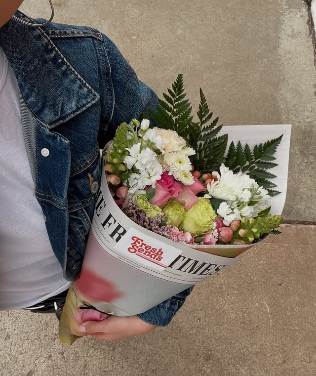 Woman holding a modern pastel bouquet from Fresh Sends featuring 2025 floral trend colors.-318453907823