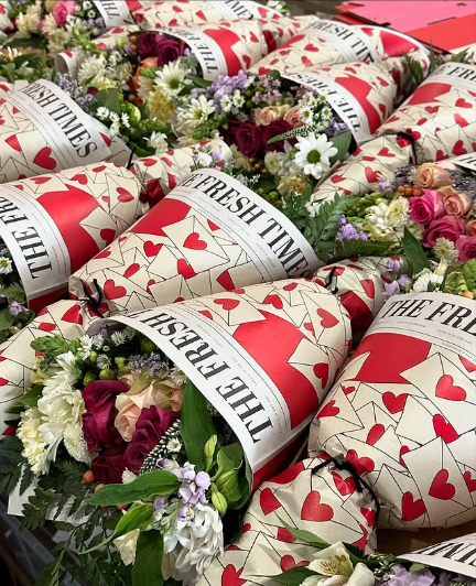 Newspaper wrapped Fresh Sends bouquets arranged side by side in minimalist fashion.-317488431471