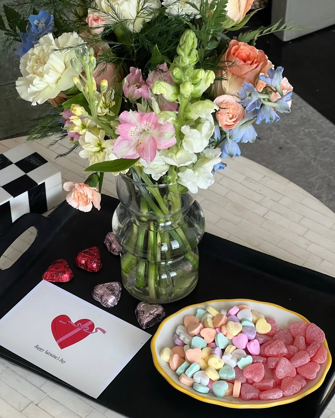 Fresh flowers in a vase with a “Happy Valentine’s Day” card and heart-shaped candies and chocolates by Fresh Sends.-319538332015
