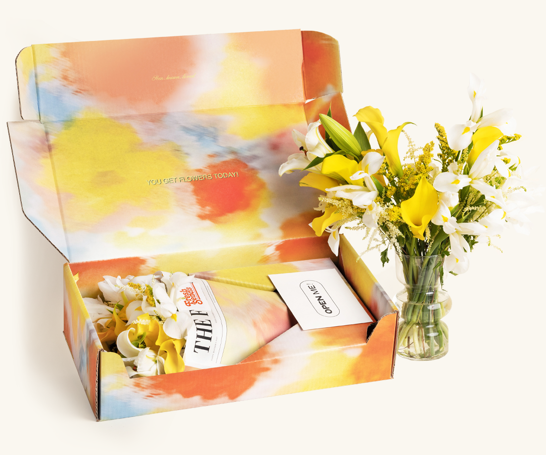 A glass vase with pink tulips and a wrapped bouquet of orange tulips on a neutral background.